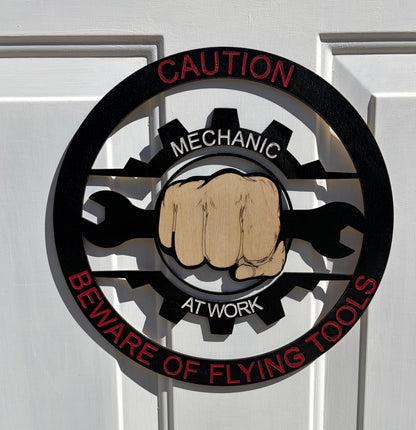 CAUTION MECHANIC AT WORK BEWARE OF FLYING TOOLS