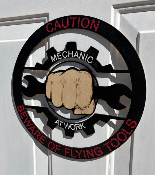CAUTION MECHANIC AT WORK BEWARE OF FLYING TOOLS